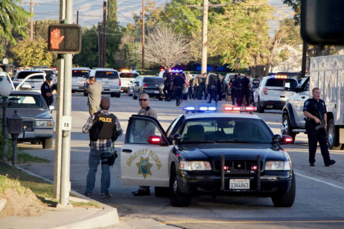 Police activity with multiple vehicles and officers present