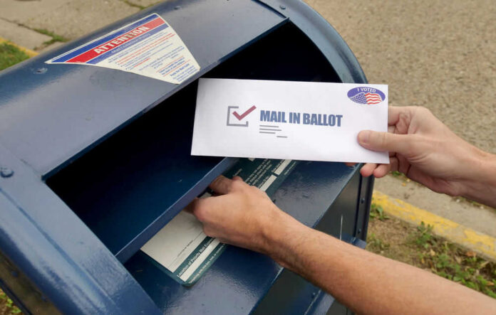 Person placing mailin ballot into mailbox