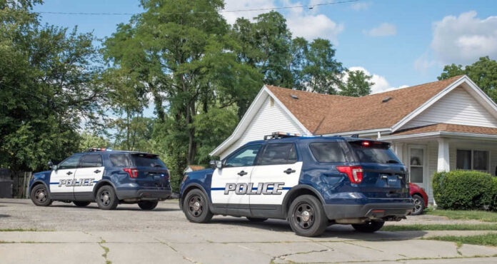 Two police SUVs outside residential house