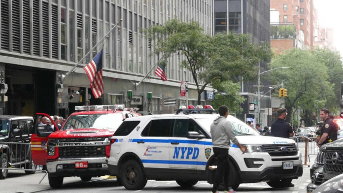Police vehicles on busy city street with people