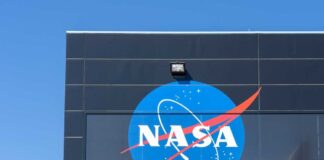 NASA logo displayed on a building against a clear blue sky