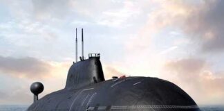 A submarine partially submerged in the ocean under a cloudy sky