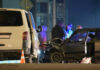 Two cars crashed at night with people nearby