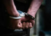 Hands in handcuffs behind the back tightly secured