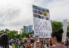 Protest with signs advocating for gun control policy