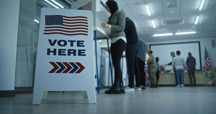 Voting station with sign and people casting ballots