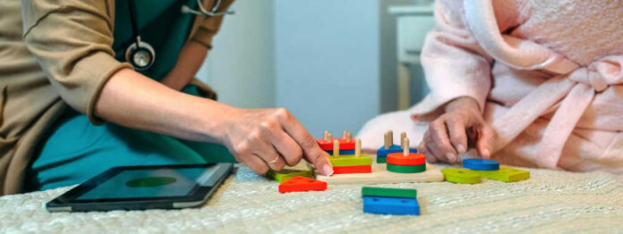 Two people sorting colorful wooden shapes together