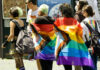 People walking with pride flags and colorful clothing