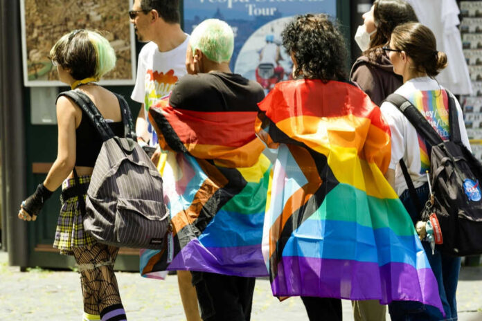 People walking with pride flags and colorful clothing