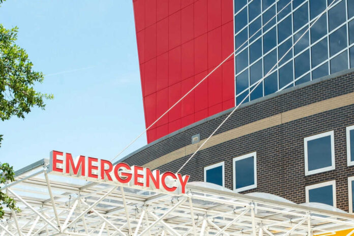Emergency sign outside modern building with windows