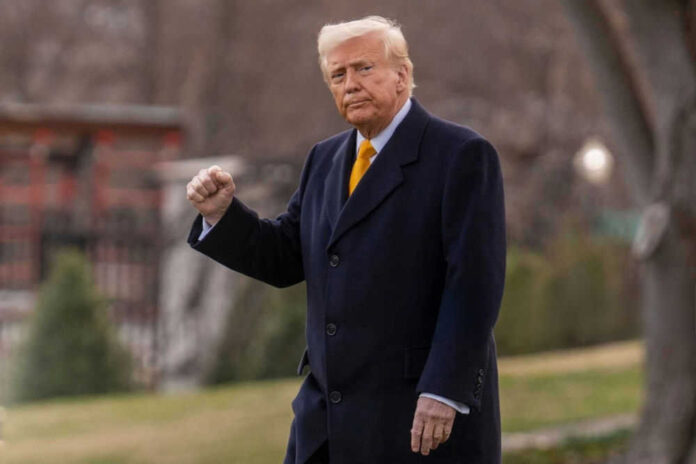 Man in suit outside with fist raised