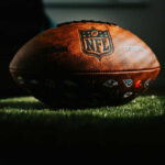Super Bowl LX Brings Highest-Level Security to Santa Clara NFL football resting on artificial grass indoors