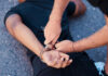 Chicago Loses 200 Criminals on Ankle Monitors Person being handcuffed on the ground outdoors