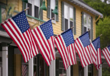 American flags displayed outside yellow building