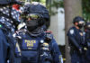 Riot police in tactical gear with face masks