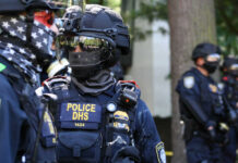 Riot police in tactical gear with face masks
