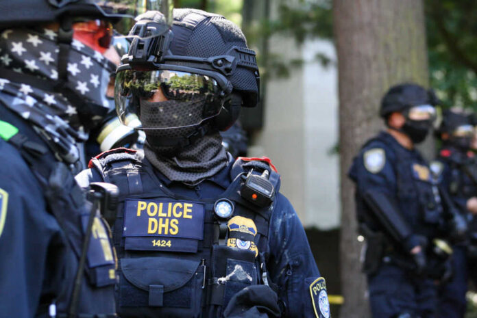 1801253863 Riot police in tactical gear with face masks